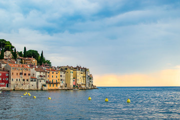View of the typical croatian old houses in the coastline of the old town of Rovinj, Croatia, just on the Adriatic Sea, during the sunset