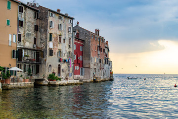 Fototapeta na wymiar View of the typical croatian old houses in the coastline of the old town of Rovinj, Croatia, just on the Adriatic Sea, during the sunset