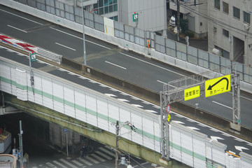 都会に張り巡らされた高速道路　急カーブの看板