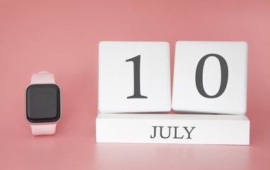 Modern Watch with cube calendar and date 10 july on pink background. Concept summer time vacation.