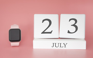 Modern Watch with cube calendar and date 23 july on pink background. Concept summer time vacation.