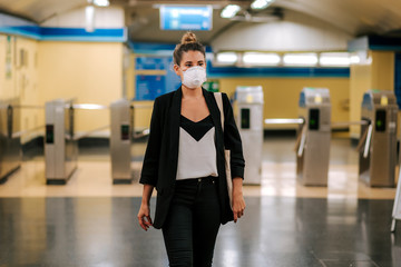 young woman with medical mask in the subway