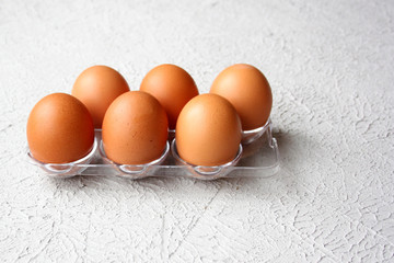 Six fresh brown chicken eggs in a plastic package. Close-up. © Lyudmila