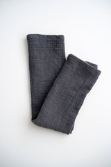 Kitchen towel made of natural flax materials of gray color on a white isolated background. Tip view.