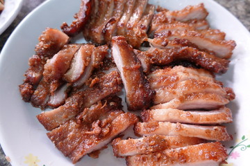 traditional Thai culture air fryer fried pork cuisine style or moo tod krob favorite famous street fast foods menu at thailand homemade
with hot spicy sauces on table wood dish sticky rice vegetable