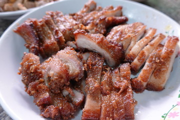 traditional Thai culture air fryer fried pork cuisine style or moo tod krob favorite famous street fast foods menu at thailand homemade
with hot spicy sauces on table wood dish sticky rice vegetable