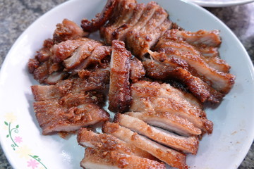 traditional Thai culture air fryer fried pork cuisine style or moo tod krob favorite famous street fast foods menu at thailand homemade
with hot spicy sauces on table wood dish sticky rice vegetable