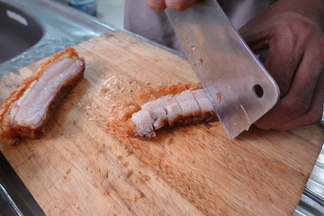 traditional Thai culture air fryer fried pork cuisine style or moo tod krob favorite famous street fast foods menu at thailand homemade
with hot spicy sauces on table wood dish sticky rice vegetable