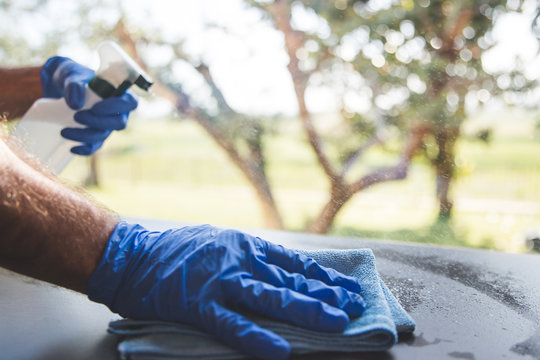 The Act Of Cleaning A Surface With Gloves And A Rag
