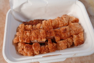 traditional Thai culture air fryer fried pork cuisine style or moo tod krob favorite famous street fast foods menu at thailand homemade
with hot spicy sauces on table wood dish sticky rice vegetable
