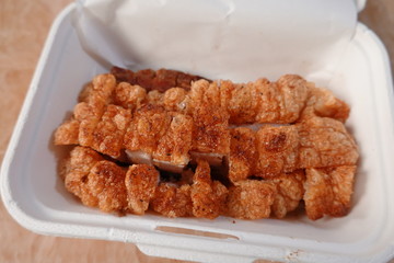 traditional Thai culture air fryer fried pork cuisine style or moo tod krob favorite famous street fast foods menu at thailand homemade
with hot spicy sauces on table wood dish sticky rice vegetable