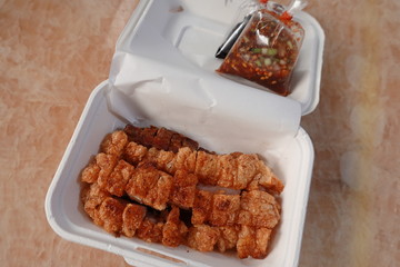 traditional Thai culture air fryer fried pork cuisine style or moo tod krob favorite famous street fast foods menu at thailand homemade
with hot spicy sauces on table wood dish sticky rice vegetable
