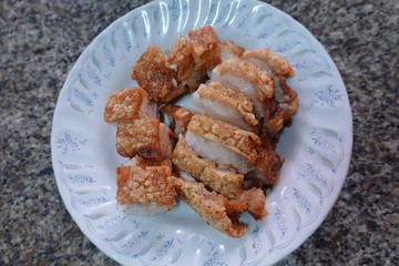 traditional Thai culture air fryer fried pork cuisine style or moo tod krob favorite famous street fast foods menu at thailand homemade
with hot spicy sauces on table wood dish sticky rice vegetable
