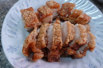 traditional Thai culture air fryer fried pork cuisine style or moo tod krob favorite famous street fast foods menu at thailand homemade
with hot spicy sauces on table wood dish sticky rice vegetable