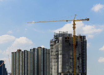 Construction cranes are working at new residential complex