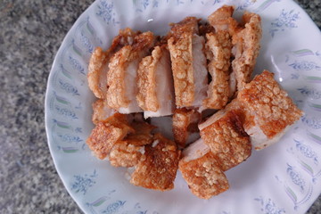 traditional Thai culture air fryer fried pork cuisine style or moo tod krob favorite famous street fast foods menu at thailand homemade
with hot spicy sauces on table wood dish sticky rice vegetable