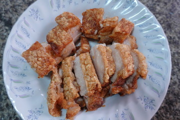traditional Thai culture air fryer fried pork cuisine style or moo tod krob favorite famous street fast foods menu at thailand homemade
with hot spicy sauces on table wood dish sticky rice vegetable