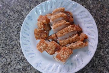 traditional Thai culture air fryer fried pork cuisine style or moo tod krob favorite famous street fast foods menu at thailand homemade
with hot spicy sauces on table wood dish sticky rice vegetable