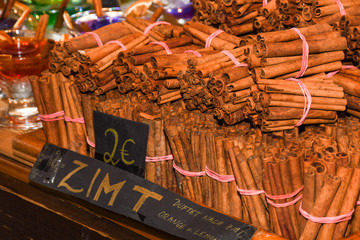 Bunch of cinnamon sticks for sale on counter top at the Christmas market.