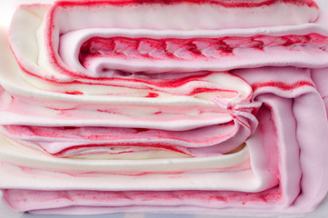 Closeup of tasty ice cream with strawberry topping as a background