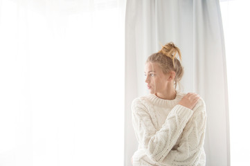 Beautiful girl near window at home
