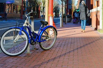 Fototapeta na wymiar Blue Bicycle Parked On Sidewalk