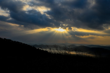 the sun's rays over tha mountain