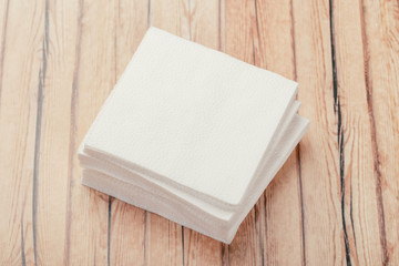 white paper napkin or tissue on the wooden table background.