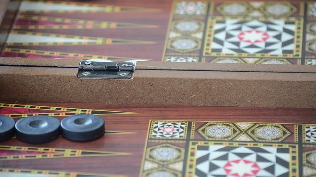 Rolling dice on a backgammon board