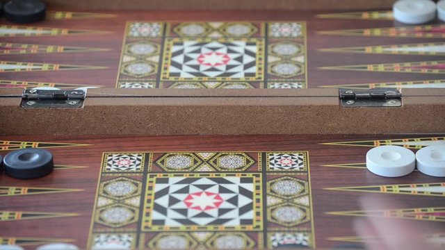 Rolling dice on a backgammon board