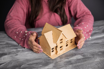 woman hand house model