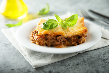 Traditional homemade lasagna served with fresh basil
