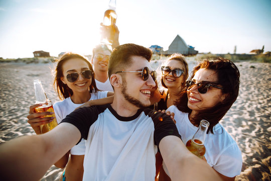 Group of young friends taking selfie and having fun on  the beach. Summer holidays, vacation, relax and lifestyle concept.