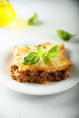 Traditional homemade lasagna served with fresh basil