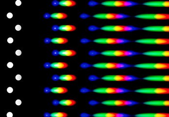 Photograph of a diffraction pattern from a line of LEDs. Image was obtained using a diffraction grating. Illustrates the distribution of energy over wavelengths in the emission spectrum of the LED