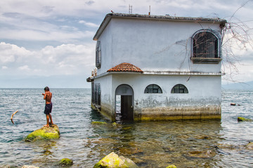 Empty house on Atitlan Lake, Guatemala, Central America. House is in water beacause water level in...