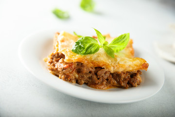 Traditional homemade lasagna served with fresh basil