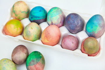 Group of Easter painted eggs in white container
