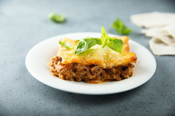 Traditional homemade lasagna served with fresh basil