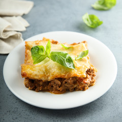 Traditional homemade lasagna served with fresh basil