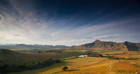 Naklejka na ściany i meble farmland landscape with wispy clouds outside Clarence, Free State, South Africa