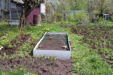 Garden greenhouses and planting seedlings in the soil. Garden vegetable garden nature.