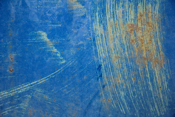 background of deeply scratched light blue surface. blue grunge texture of blue metal. concept of...