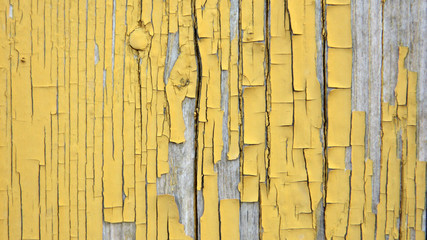 blurred background of boards covered with an old layer of yellow paint