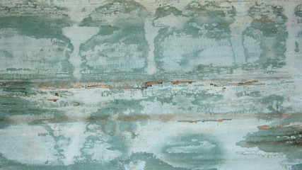 background of old wood planks painted with light blue paint. drips of white paint on an old blue background
