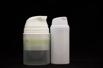 white plastic cosmetic bottle on black background