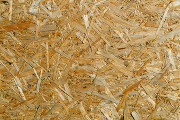 Natural yellow background from particle board close up