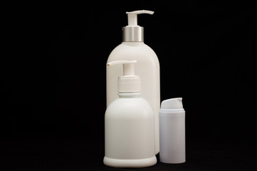 white plastic cosmetic bottle on black background