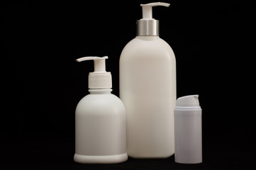 white plastic cosmetic bottle on black background