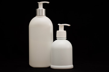 white plastic cosmetic bottle on black background